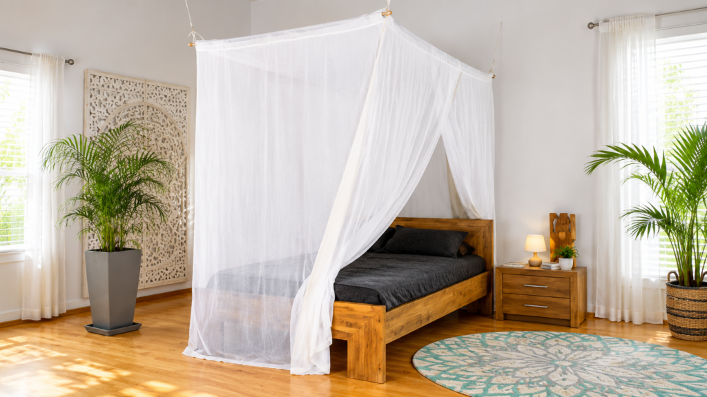 White mosquito net canopy over a wooden bed in a bright bedroom